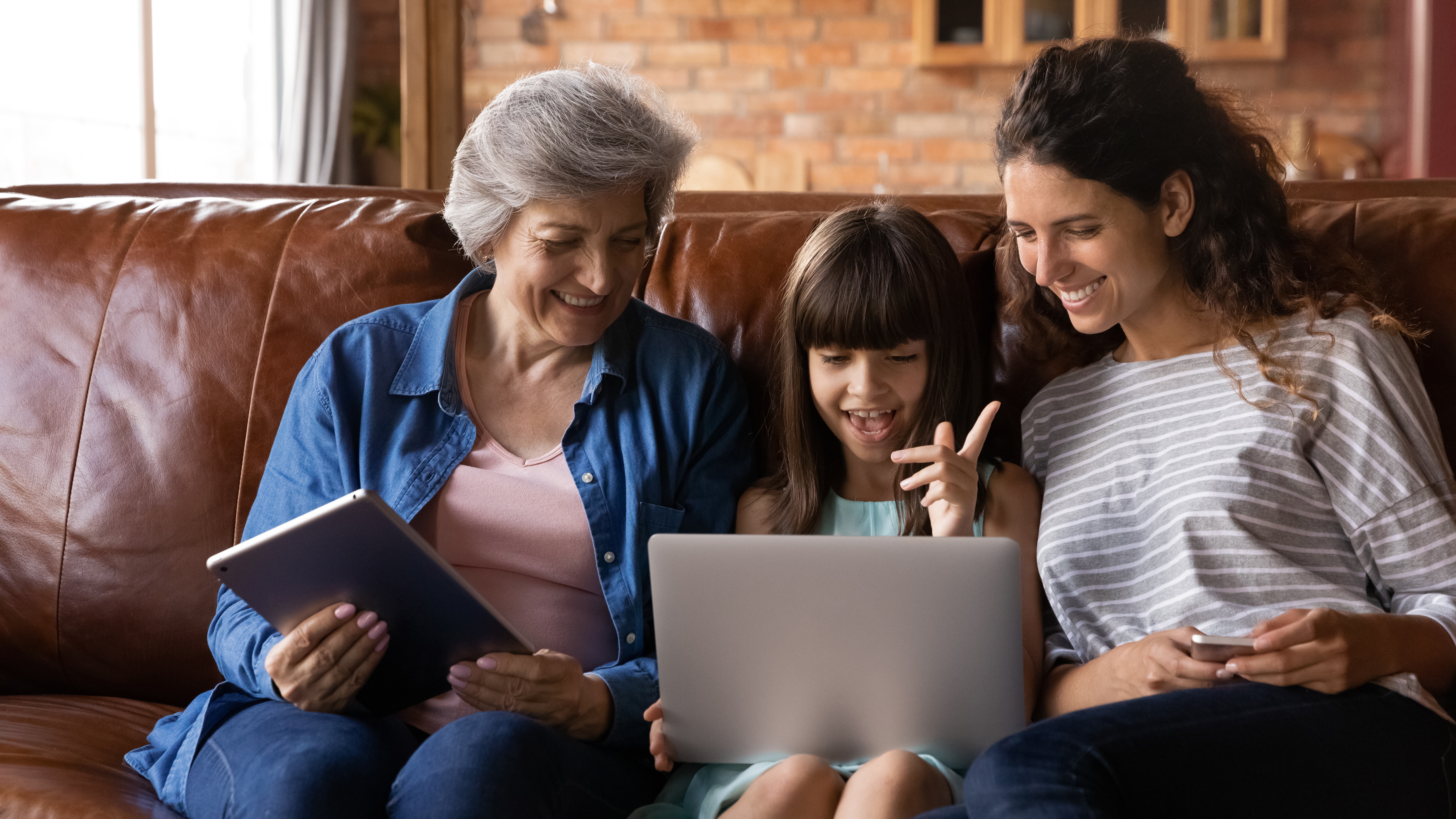 image of a family sitting on a couch looking at a computer