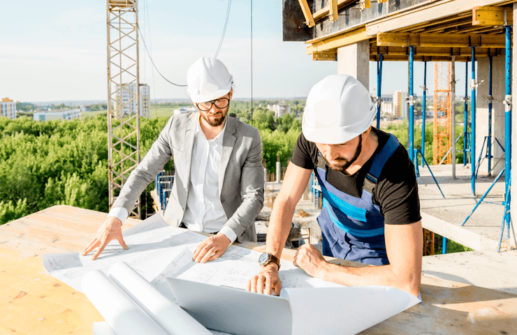 construction workers looking at blueprint plans