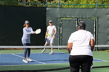 2 pickleball players in the middle of a match