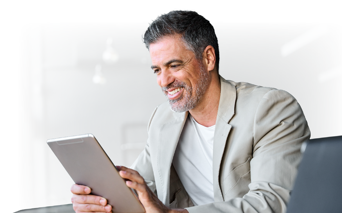 business professional smiling while working on tablet