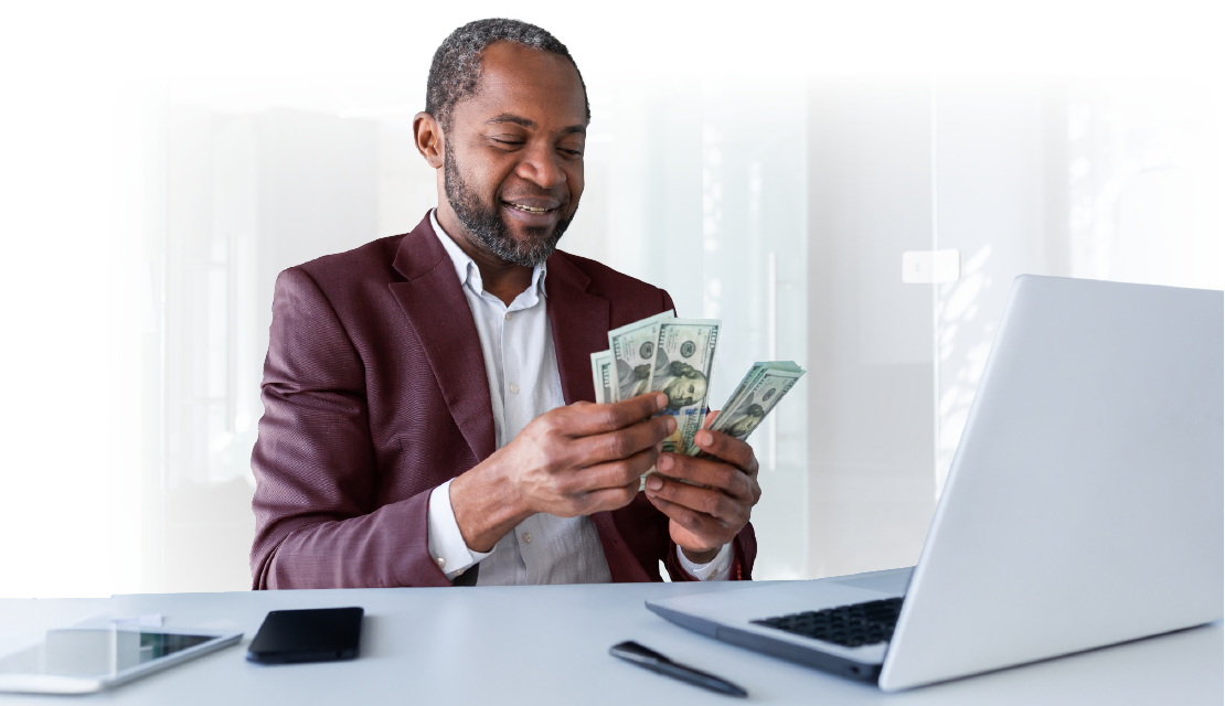 business professional at his desk counting money