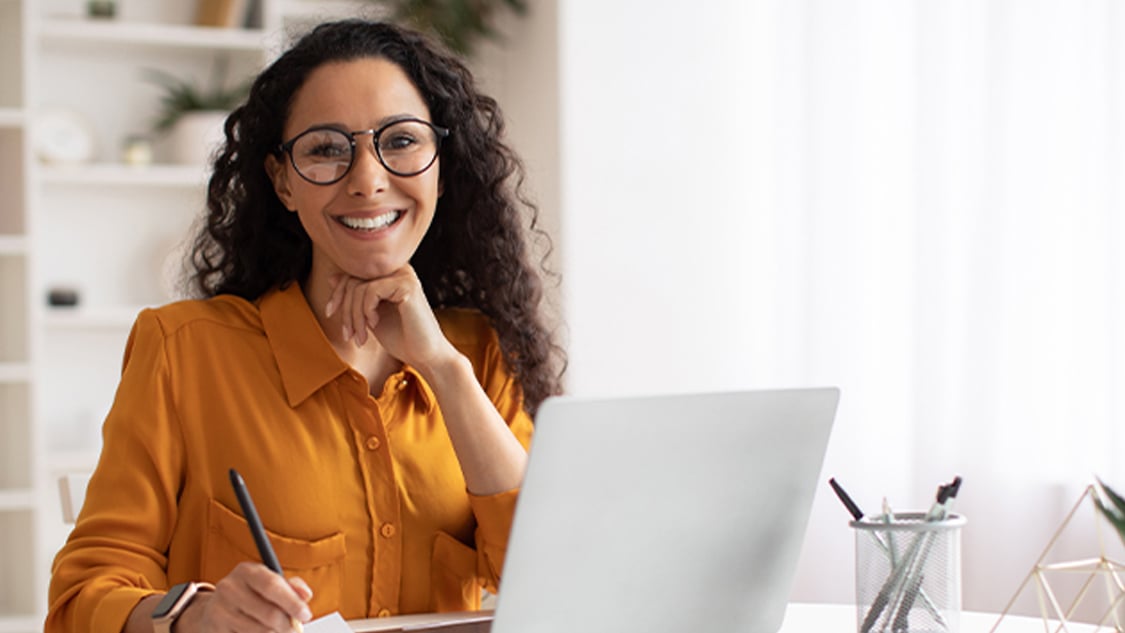 Image of a female agent sitting at her desk