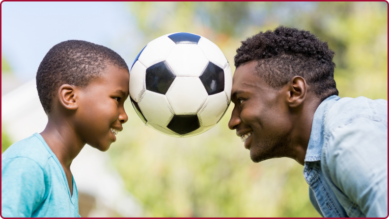 image of father and son playing soccer