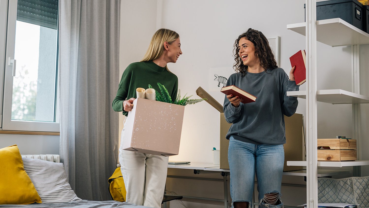 Two young girls moving into there dorm room