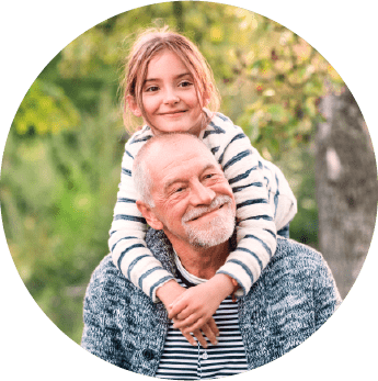 circular photo of a granddaughter smiling on her grandfather's shoulders