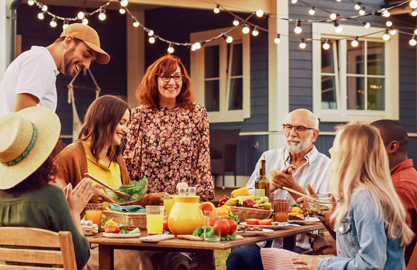 family enjoying an outdoor meal together