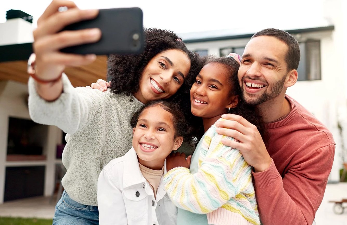 Family smiling and taking a selfie togther