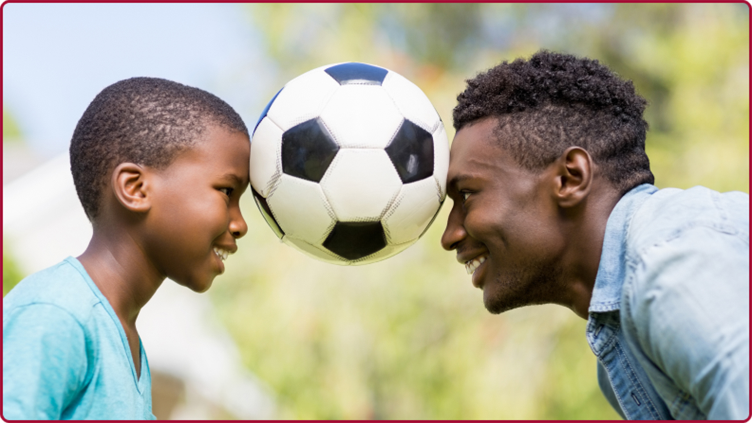 image of a father and son playing soccer